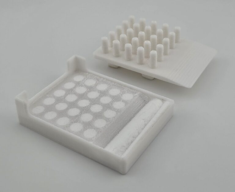 The multitool part is used to pack the powder into the divots and sweep the excess into the basin